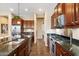 Well-equipped kitchen with stainless steel appliances, granite countertops and wood cabinetry at 5621 E Lonesome Trl, Cave Creek, AZ 85331