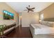 Comfortable main bedroom featuring hardwood floors, a ceiling fan, and a stylish console table at 5621 E Lonesome Trl, Cave Creek, AZ 85331