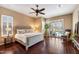 Spacious main bedroom with hardwood floors, a ceiling fan, and views of the pool at 5621 E Lonesome Trl, Cave Creek, AZ 85331