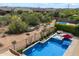 Aerial view of a private backyard pool with spa, shaded patio, and desert landscaping at 5621 E Lonesome Trl, Cave Creek, AZ 85331