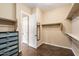 Spacious walk-in closet includes multiple shelves and dark cabinet, perfect for organizing clothes and accessories at 5621 E Lonesome Trl, Cave Creek, AZ 85331