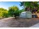 Backyard view of storage shed, mature trees, with lots of space for outdoor activities at 6101 E Thunderbird Rd, Scottsdale, AZ 85254