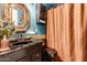 Stylish bathroom featuring a black sink, decorative mirror, and modern fixtures at 6101 E Thunderbird Rd, Scottsdale, AZ 85254