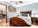 Elegant bedroom featuring a dark wood bed frame and an adjacent doorway at 6101 E Thunderbird Rd, Scottsdale, AZ 85254