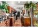 The kitchen is equipped with wood cabinets, black appliances, and a beautiful view of the backyard at 6101 E Thunderbird Rd, Scottsdale, AZ 85254