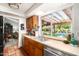 Kitchen area featuring natural light over double sinks and a view of the backyard and in-ground pool at 6101 E Thunderbird Rd, Scottsdale, AZ 85254