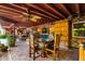 Expansive covered patio with multiple seating areas, ceiling fans, and tiled flooring at 6101 E Thunderbird Rd, Scottsdale, AZ 85254