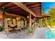 Expansive covered patio featuring outdoor dining, and views of the pool and landscaped backyard at 6101 E Thunderbird Rd, Scottsdale, AZ 85254