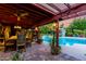 Inviting poolside patio area with outdoor dining, lush landscaping, and tranquil atmosphere at 6101 E Thunderbird Rd, Scottsdale, AZ 85254