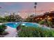 Refreshing backyard pool featuring mature landscaping and ambient lighting creating a peaceful retreat for outdoor enjoyment at 6101 E Thunderbird Rd, Scottsdale, AZ 85254