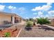 Expansive gravel backyard featuring a covered patio, desert landscaping and decorative features and a block fence at 6237 E Boston St, Mesa, AZ 85205