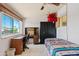 Bright bedroom with a desk, large window, and comfortable-looking bed at 6237 E Boston St, Mesa, AZ 85205