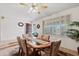 Cozy dining area featuring an inviting dining table set, with tile flooring and natural light streaming through the shutters at 6237 E Boston St, Mesa, AZ 85205