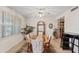 Formal dining room featuring elegant table with seating for eight, tile flooring, and natural light from the window at 6237 E Boston St, Mesa, AZ 85205
