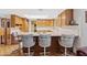 Breakfast bar with seating in a well-lit kitchen area featuring wood cabinetry and a bright skylight at 6237 E Boston St, Mesa, AZ 85205