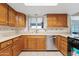 Well-lit kitchen with stainless steel appliances, wood cabinets, and white countertops, perfect for home cooking at 6237 E Boston St, Mesa, AZ 85205