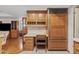 Bright kitchen area featuring wood cabinets, desk, and built-in refrigerator at 6237 E Boston St, Mesa, AZ 85205