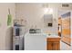 Functional laundry area with a modern washing machine and utility sink at 6237 E Boston St, Mesa, AZ 85205