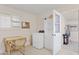 Well-lit laundry room with a washer, cabinets, a window, and a small desk at 6237 E Boston St, Mesa, AZ 85205