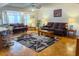Bright living room with bay windows, hardwood floors, ceiling fan, and stylish rug at 6237 E Boston St, Mesa, AZ 85205