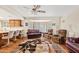 Cozy living area with hardwood floors, open to the kitchen, featuring comfortable sofas and a large bay window at 6237 E Boston St, Mesa, AZ 85205