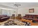 Spacious living room with hardwood floors, neutral walls, ceiling fan, and comfortable seating with natural light at 6237 E Boston St, Mesa, AZ 85205