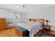 Comfortable main bedroom with a ceiling fan and a storage chest at the foot of the bed at 6237 E Boston St, Mesa, AZ 85205