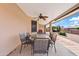 Covered patio features tile flooring, dining table set, ceiling fan and views of the expansive gravel backyard at 6237 E Boston St, Mesa, AZ 85205