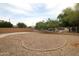 Landscaped backyard with decorative rock feature and a concrete patio at 7151 W Lamar Rd, Glendale, AZ 85303
