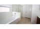 Bright tub and shower combo with tile surround, next to a glass enclosed shower at 7151 W Lamar Rd, Glendale, AZ 85303