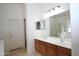 Bright bathroom with double sinks and a large mirror, next to a separate glass enclosed shower at 7151 W Lamar Rd, Glendale, AZ 85303