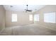 Spacious bedroom with ceiling fan, neutral walls, and large windows, offering ample natural light at 7151 W Lamar Rd, Glendale, AZ 85303