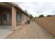 Side yard featuring gravel, with a wall at 7151 W Lamar Rd, Glendale, AZ 85303