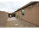 Side yard featuring gravel, a wall, with trashcans at 7151 W Lamar Rd, Glendale, AZ 85303