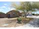 The residence includes a verdant tree, a xeriscaped lawn, and tasteful exterior details at 7151 W Lamar Rd, Glendale, AZ 85303