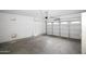 Clean garage featuring a roll-up door, ready for parking or storage at 7151 W Lamar Rd, Glendale, AZ 85303