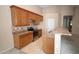 Bright open kitchen with tile floors, stainless steel appliances, and breakfast bar at 7151 W Lamar Rd, Glendale, AZ 85303