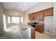 Open kitchen with breakfast bar, tile flooring, dining area with bay windows and plenty of natural light at 7151 W Lamar Rd, Glendale, AZ 85303