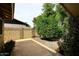 View of a spacious backyard with desert landscaping, block fence and mature greenery at 7521 S College Ave, Tempe, AZ 85283