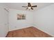 Bedroom with hardwood floors, ceiling fan, and closet at 7521 S College Ave, Tempe, AZ 85283
