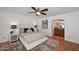 Comfortable bedroom with ceiling fan, ensuite bathroom access, and neutral decor at 7521 S College Ave, Tempe, AZ 85283