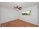 Bedroom with hardwood floors, ceiling fan, and natural light at 7521 S College Ave, Tempe, AZ 85283