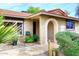 Charming front entrance with unique arched doorway, tiled walkway, and desert landscaping at 7521 S College Ave, Tempe, AZ 85283
