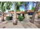 Charming single-story home with a beautiful red tile roof, desert landscaping, and mature trees at 7521 S College Ave, Tempe, AZ 85283
