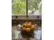 A bowl of lemons sits on a granite countertop with a window and greenery view at 7521 S College Ave, Tempe, AZ 85283