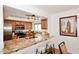The kitchen features granite counters, modern appliances, breakfast bar, and recessed lighting at 7521 S College Ave, Tempe, AZ 85283