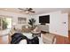 Cozy living room with a media center, stylish decor, comfortable seating, and easy access to the outdoors at 7521 S College Ave, Tempe, AZ 85283
