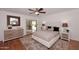 Main bedroom with dresser, ceiling fan, en-suite bathroom, and sliding glass door at 7521 S College Ave, Tempe, AZ 85283
