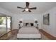 Main bedroom with ceiling fan, en-suite bathroom, and sliding glass door at 7521 S College Ave, Tempe, AZ 85283