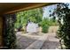 White storage shed nestled amongst the well-maintained backyard landscaping at 7521 S College Ave, Tempe, AZ 85283